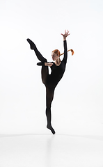 Image showing Young and graceful ballet dancer in minimal black style isolated on white studio background