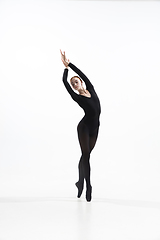Image showing Young and graceful ballet dancer in minimal black style isolated on white studio background