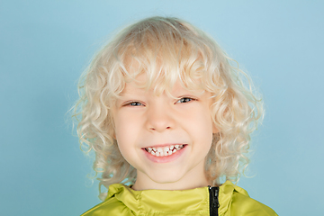 Image showing Portrait of beautiful caucasian little boy isolated on blue studio background