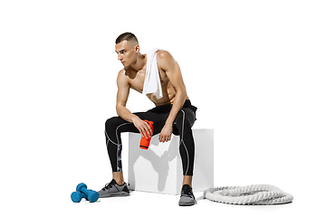 Image showing Beautiful young male athlete practicing on white studio background with shadows