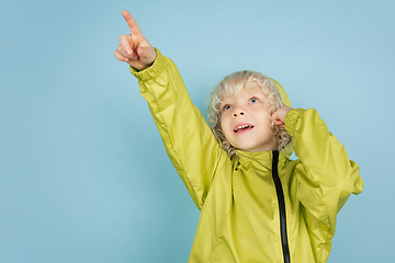 Image showing Portrait of beautiful caucasian little boy isolated on blue studio background