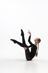 Image showing Young and graceful ballet dancer in minimal black style isolated on white studio background