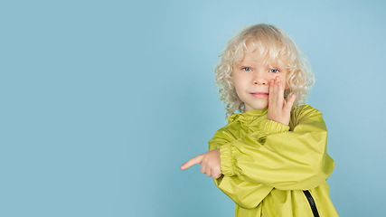 Image showing Portrait of beautiful caucasian little boy isolated on blue studio background