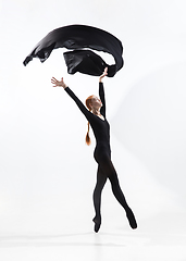 Image showing Young and graceful ballet dancer in minimal black style isolated on white studio background