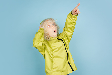 Image showing Portrait of beautiful caucasian little boy isolated on blue studio background