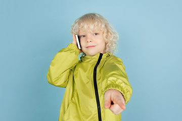 Image showing Portrait of beautiful caucasian little boy isolated on blue studio background