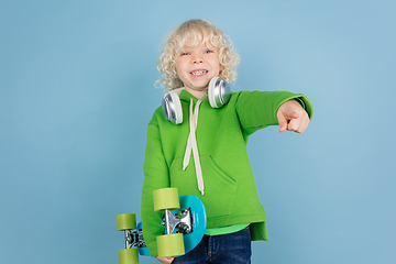 Image showing Portrait of beautiful caucasian little boy isolated on blue studio background