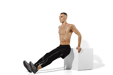 Image showing Beautiful young male athlete practicing on white studio background with shadows