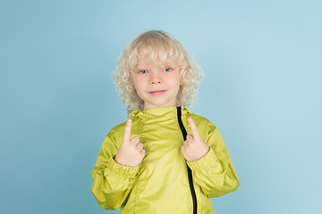 Image showing Portrait of beautiful caucasian little boy isolated on blue studio background