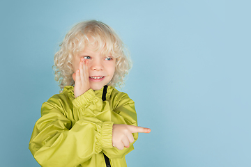 Image showing Portrait of beautiful caucasian little boy isolated on blue studio background