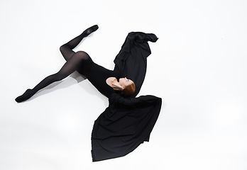 Image showing Young and graceful ballet dancer in minimal black style isolated on white studio background