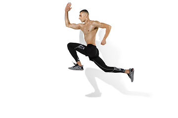 Image showing Beautiful young male athlete practicing on white studio background with shadows