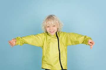 Image showing Portrait of beautiful caucasian little boy isolated on blue studio background