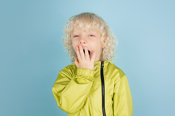 Image showing Portrait of beautiful caucasian little boy isolated on blue studio background