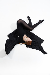 Image showing Young and graceful ballet dancer in minimal black style isolated on white studio background