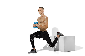 Image showing Beautiful young male athlete practicing on white studio background with shadows