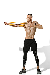 Image showing Beautiful young male athlete practicing on white studio background with shadows