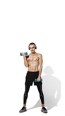 Image showing Beautiful young male athlete practicing on white studio background with shadows