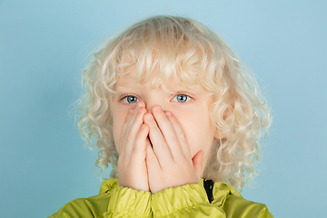 Image showing Portrait of beautiful caucasian little boy isolated on blue studio background