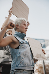 Image showing Group of activists giving slogans in a rally. Men and women marching together in a protest in the city.