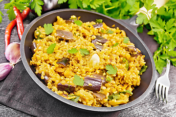 Image showing Bulgur with eggplant in pan on black board