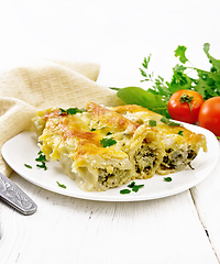 Image showing Cannelloni with curd and spinach in plate on table