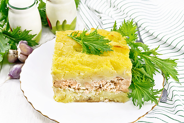 Image showing Casserole with potatoes and fish in plate on board