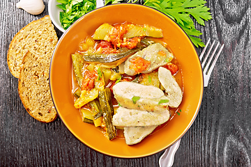 Image showing Chicken with stewed zucchini in plate on board top