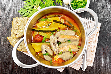Image showing Chicken with stewed zucchini in saucepan on board top