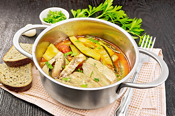 Image showing Chicken with stewed zucchini in saucepan on board