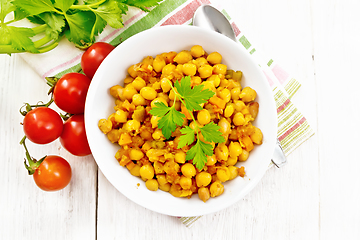 Image showing Chickpeas stewed with vegetables in plate on board top