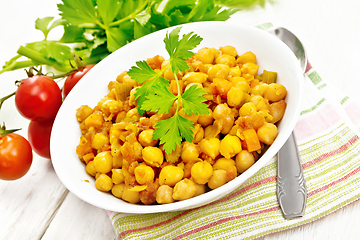 Image showing Chickpeas stewed with vegetables in plate on white board