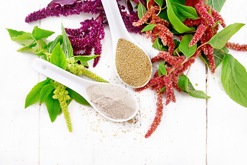 Image showing Flour and seeds amaranth in spoons on light board top