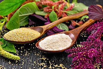 Image showing Flour and seeds amaranth in two spoons on dark board