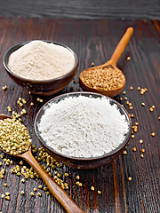 Image showing Flour buckwheat green and brown in bowls on dark board