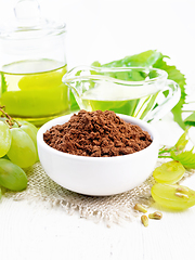 Image showing Flour grape seed in bowl on white wooden board