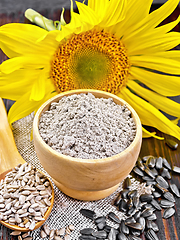 Image showing Flour sunflower in bowl with flower on dark board