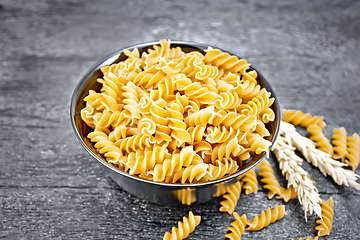 Image showing Fusilli whole grain in bowl on dark board