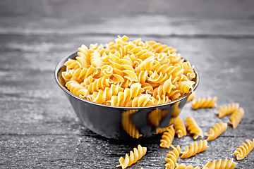 Image showing Fusilli whole grain in bowl on wooden board