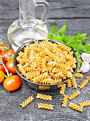 Image showing Fusilli whole grain in bowl with vegetables on black board