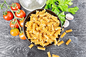 Image showing Fusilli whole grain in bowl with vegetables on board top