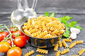 Image showing Fusilli whole grain in bowl with vegetables on board
