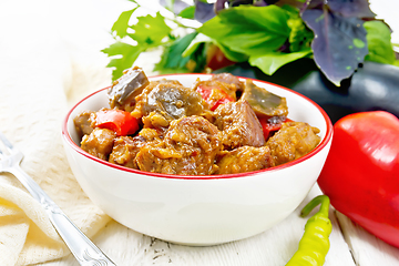 Image showing Meat with eggplant and pepper in bowl on light board