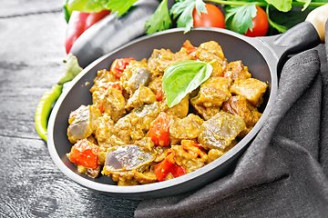 Image showing Meat with eggplant and pepper in pan on black board