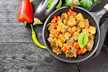 Image showing Meat with eggplant and pepper in pan on board top