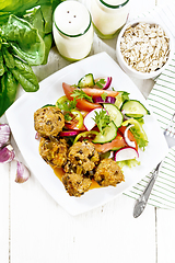 Image showing Meatballs with spinach and oatmeal on light board top