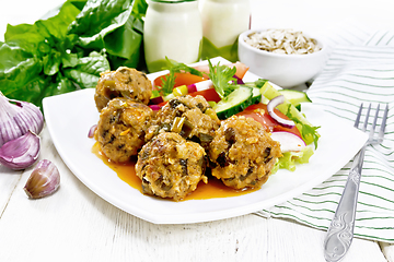 Image showing Meatballs with spinach and oatmeal on wooden board