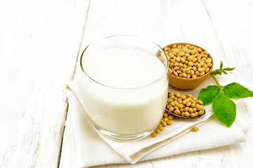 Image showing Milk soy in glass with leaf on light board