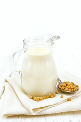 Image showing Milk soy in jug on wooden board