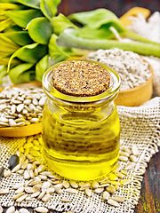 Image showing Oil sunflower in jar with flour on burlap